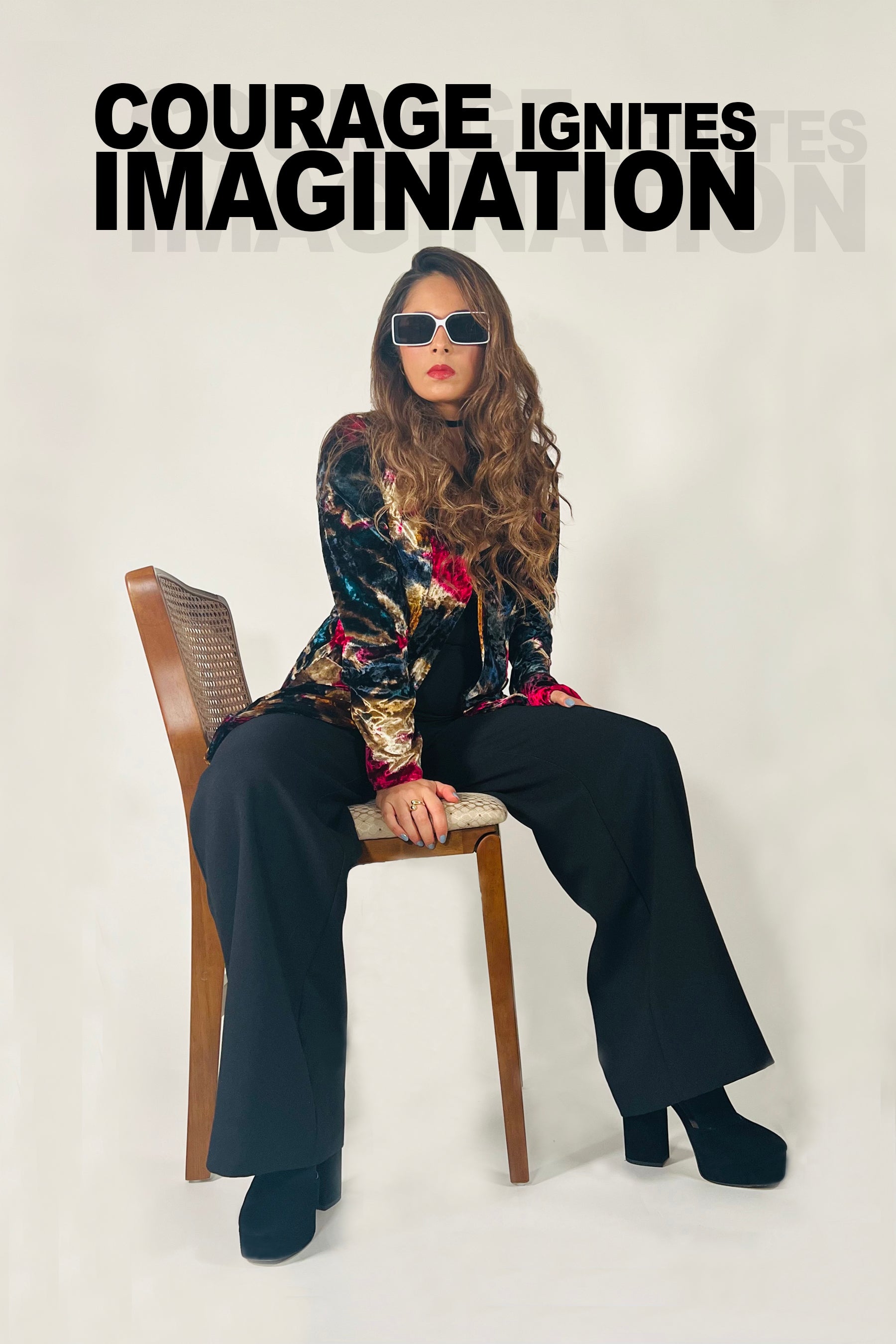 Woman sitting on a chair with sunglasses, text 'COURAGE IGNITES IMAGINATION' above her.